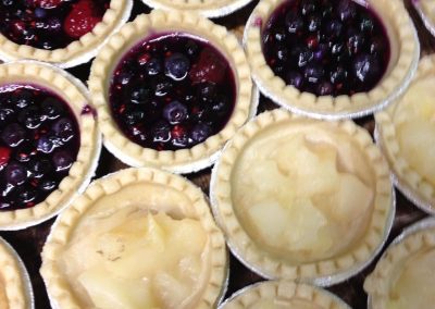 Small apple & blackcurrant tarts in production